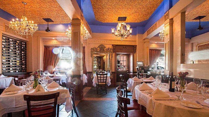 Dining room with set tables and chandeliers