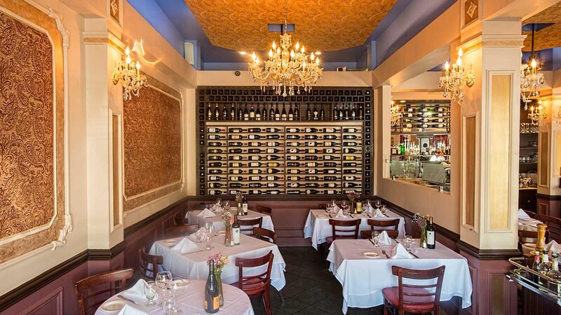 Dining room with view of set tables and wine rack wall decoration