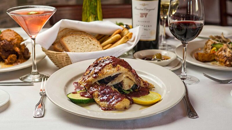 Chicken in a wine sauce with side of spinach and zucchini