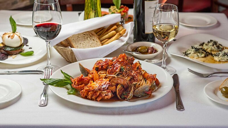 Clams and shrimp topped with pasta and red sauce